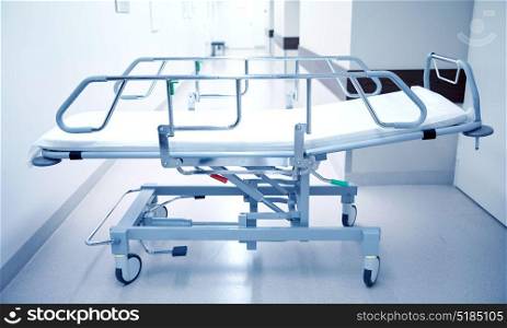 healthcare, reanimation, emergency room and medicine concept - gurney or wheeled stretcher at hospital corridor. hospital gurney or stretcher at emergency room
