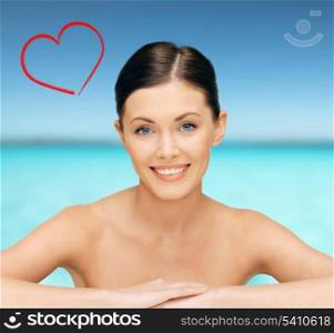 healthcare, spa and beauty concept - face and hands of beautiful woman