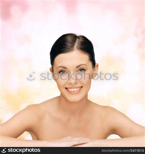 healthcare, spa and beauty concept - face and hands of beautiful woman