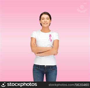 healthcare, support, people and medicine concept - smiling woman in blank white t-shirt with breast cancer awareness ribbon over pink background
