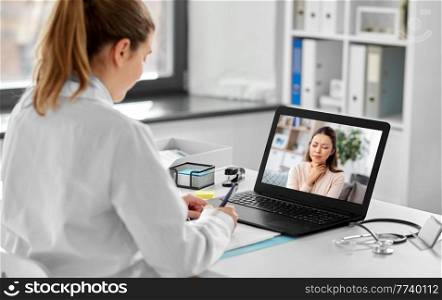 healthcare, technology and medicine concept - female doctor having video call with sick woman patient on laptop computer at hospital. doctor having video call with patient on laptop