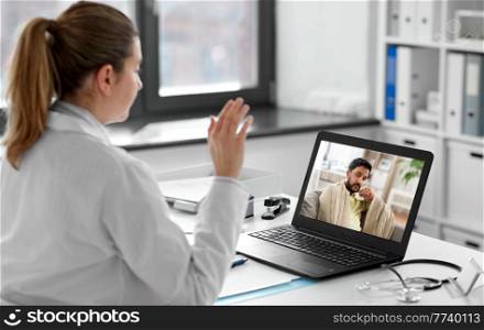 healthcare, technology and medicine concept - female doctor having video call with sick man patient on laptop computer at hospital. doctor having video call with patient on laptop
