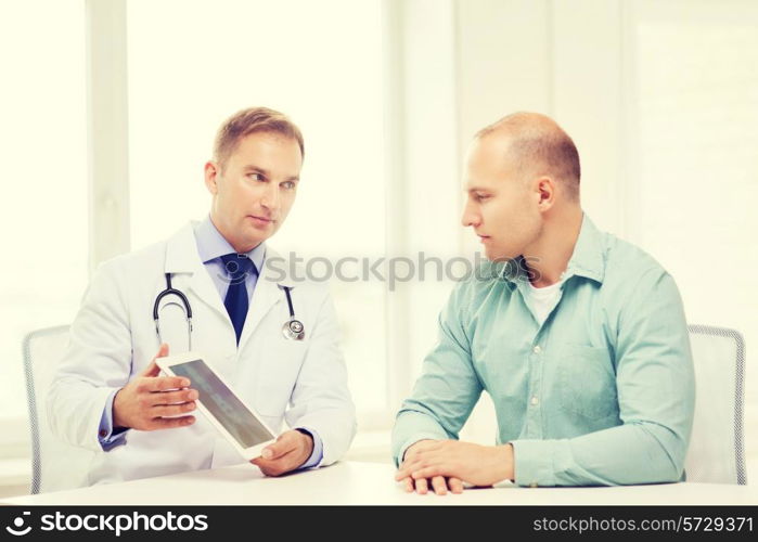 healthcare, technology and medicine concept - serious doctor with tablet pc computer and patient in hospital