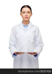 healthcare, technology and medicine concept - serious female doctor and tablet pc computer