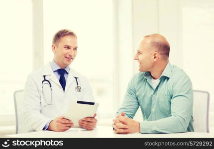 healthcare, technology and medicine concept - smiling doctor with tablet pc computer and patient in hospital