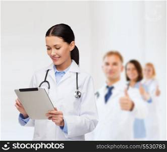 healthcare, technology and medicine concept - smiling female doctor with stethoscope and tablet pc computer