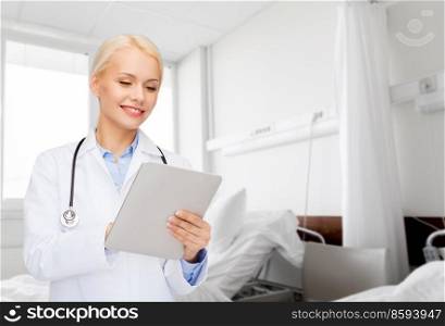 healthcare, technology and medicine concept - smiling female doctor with tablet pc computer over hospital ward background. smiling female doctor with tablet pc in hospital
