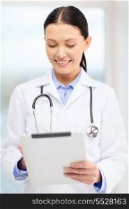 healthcare, technology and medicine concept - smiling young doctor with tablet pc computer and sthethoscope in cabinet