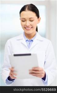 healthcare, technology and medicine concept - smiling young doctor with tablet pc computer in cabinet