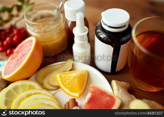 healthcare, traditional medicine, flu and ethnoscience concept - natural remedies and drugs on wooden table