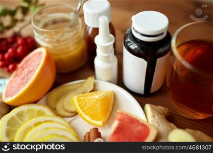 healthcare, traditional medicine, flu and ethnoscience concept - natural remedies and drugs on wooden table