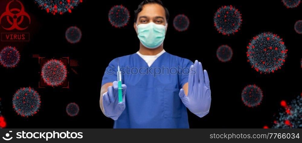 healthcare, vaccination and medicine concept - doctor or male nurse in blue uniform, face protective medical mask and gloves with syringe over virus virions on black background. male doctor in mask and gloves with syringe