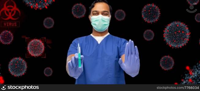healthcare, vaccination and medicine concept - doctor or male nurse in blue uniform, face protective medical mask and gloves with syringe over virus virions on black background. male doctor in mask and gloves with syringe