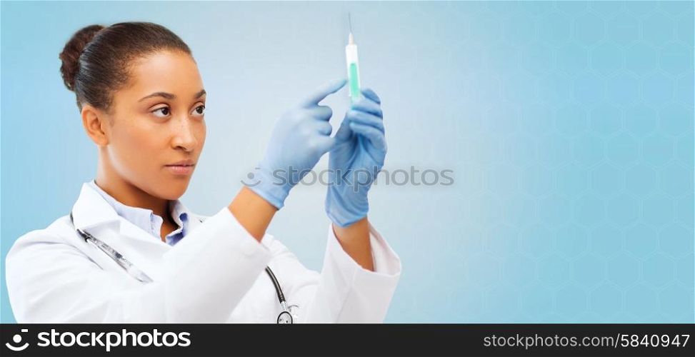 healthcare, vaccination, anesthesia and medical concept - african american female doctor holding syringe with injection over blue background