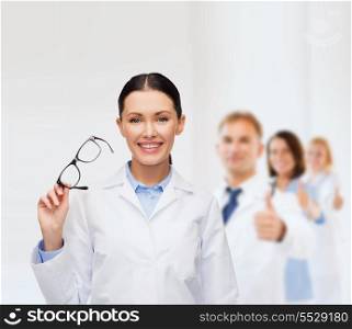 healthcare, vision and medicine concept - smiling female doctor with eyeglasses