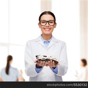 healthcare, vision and medicine concept - smiling female doctor with eyeglasses