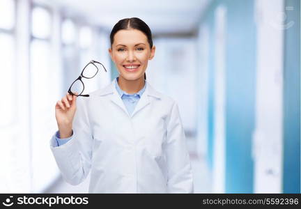 healthcare, vision and medicine concept - smiling female doctor without stethoscope