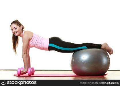 Healthy active lifestyle. Woman with gym ball and dumb bells doing exercise, isolated on white background