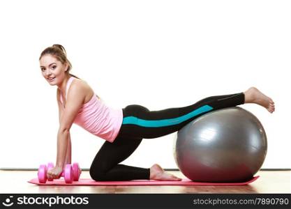 Healthy active lifestyle. Woman with gym ball and dumb bells doing exercise, isolated on white background