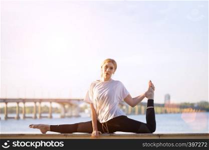 Healthy and fly Yoga Concept. fitness - beautiful girl sitting on a twine