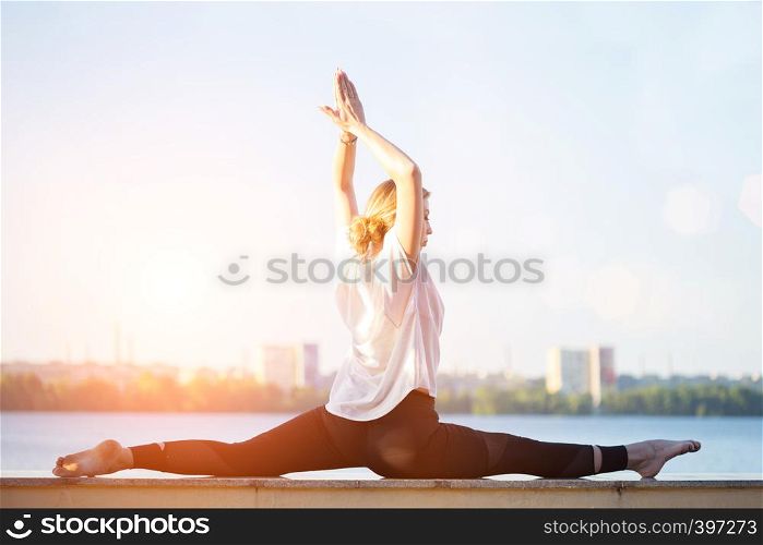 Healthy and fly Yoga Concept. fitness - beautiful girl sitting on a twine