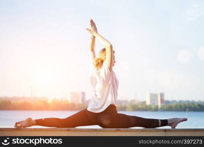 Healthy and fly Yoga Concept. fitness - beautiful girl sitting on a twine