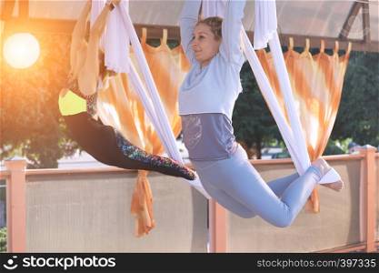 Healthy and fly Yoga Concept. happy smiling girl in a fly yoga class