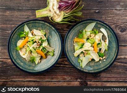 healthy and fresh artichoke salad with oranges and hazelnut