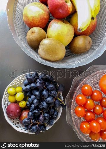 Healthy and fresh various fruit in a bowl on the table top view, grapes, apples, bananas healthy lifestyle colorful. Healthy and fresh various fruit in a bowl on the table top view, grapes, apples, bananas healthy lifestyle