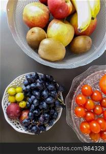 Healthy and fresh various fruit in a bowl on the table top view, grapes, apples, bananas healthy lifestyle colorful. Healthy and fresh various fruit in a bowl on the table top view, grapes, apples, bananas healthy lifestyle