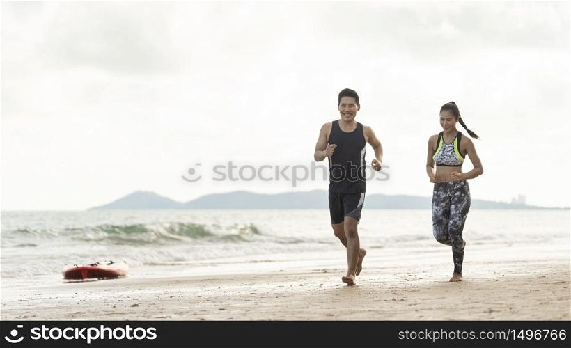 Healthy Asian couples jogging on the seaside in summer on weekend or outdoor exercise after unlocking down from COVID 19