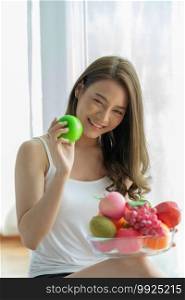 Healthy Asian woman holding fresh healthy fruits and happiness,Health care Concept