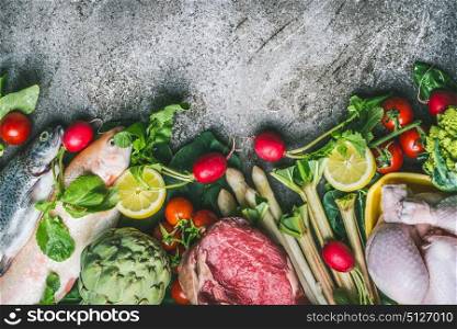 Healthy balanced eating and diet nutrition concept. Various organic foods ingredients: fish,meat,poultry,chicken,vegetables and greens seasoning on gray stone background, top view, border