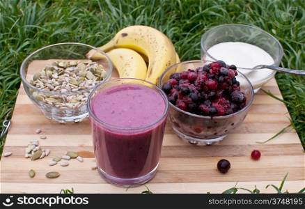 healthy berries juice smootie on wooden board