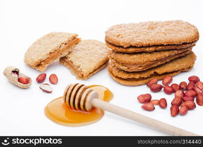 Healthy bio breakfast grain biscuits with honey and peanuts on white background