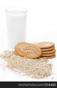 Healthy bio breakfast grain biscuits with milk and raw oats on white background