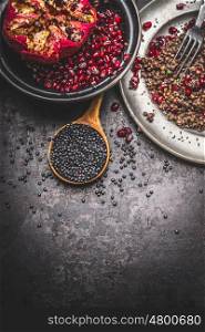 Healthy Black beluga lentil seeds cooking on dark rustic background, top view, place for text