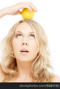 healthy blond holding lemon on her head over white