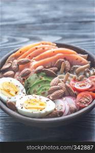 Healthy bowl with salmon, avocado, egg and vegs