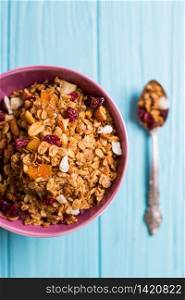 healthy breakfast. appetizing healthy granola in bowl on blue wooden background