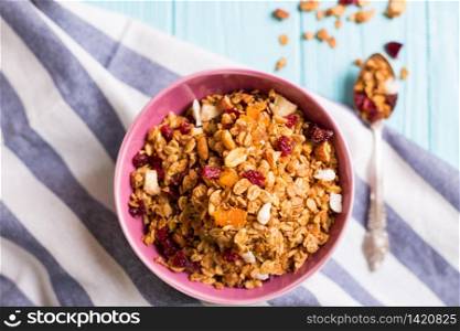 healthy breakfast. appetizing healthy granola in bowl on blue wooden background