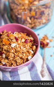 healthy breakfast. appetizing healthy granola in bowl on blue wooden background