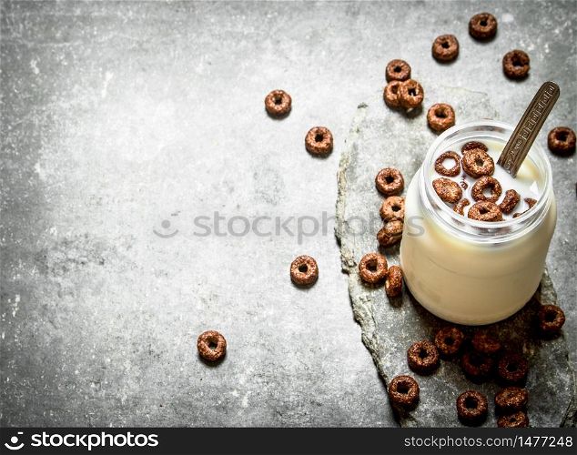 Healthy Breakfast. Chocolate cereal with milk. On the stone table.. Healthy Breakfast. Chocolate cereal with milk.