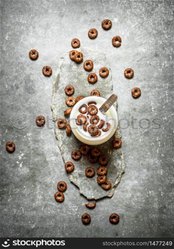 Healthy Breakfast. Chocolate cereal with milk. On the stone table.. Healthy Breakfast. Chocolate cereal with milk.