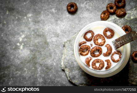 Healthy Breakfast. Chocolate cereal with milk. On the stone table.. Healthy Breakfast. Chocolate cereal with milk.