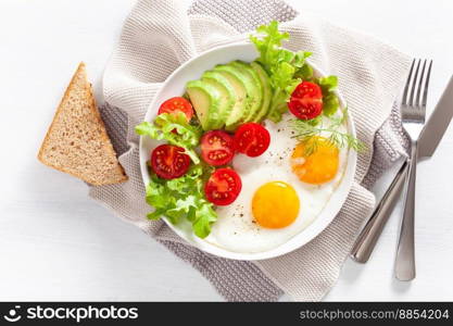 healthy breakfast flat lay. fried eggs, avocado, tomato, toasts