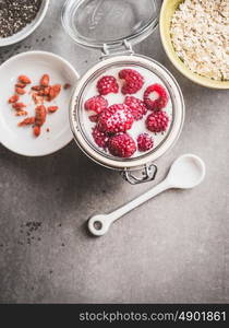 Healthy breakfast in glass jar with yogurt and berries, top view, close up