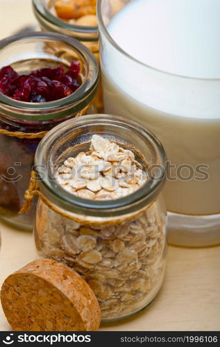 healthy breakfast ingredients milk oat cashew nuts dried cramberry craisinns