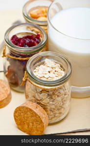 healthy breakfast ingredients milk oat cashew nuts dried cramberry craisinns 