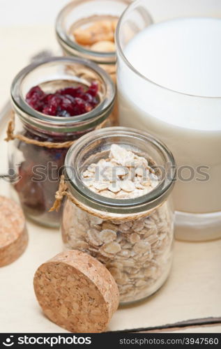 healthy breakfast ingredients milk oat cashew nuts dried cramberry craisinns